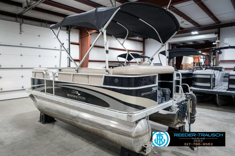 Slide: The Image of 2011 Bennington 17 Sli pontoon boat with canopy in indoor storage. - 10