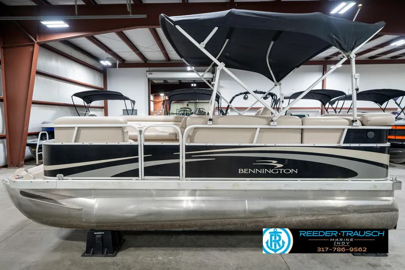 Slide: The Image of 2011 Bennington 17 Sli pontoon boat with canopy in indoor showroom. - 11