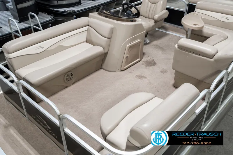 Slide: The Image of 2011 Bennington 17 Sli pontoon boat interior with beige seating and steering console. - 12