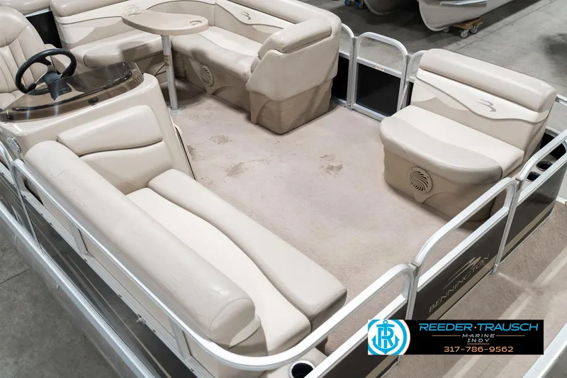 Slide: The Image of 2011 Bennington 17 Sli pontoon boat interior with beige seating and steering console. - 13