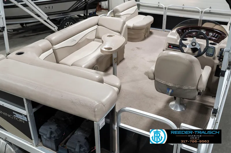 Slide: The Image of 2011 Bennington 17 Sli pontoon boat interior with beige seating and steering console. - 14
