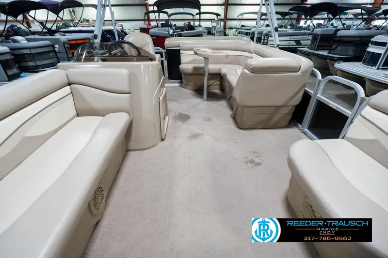 Slide: The Image of 2011 Bennington 17 Sli pontoon boat interior with beige seating and carpeted floor. - 16