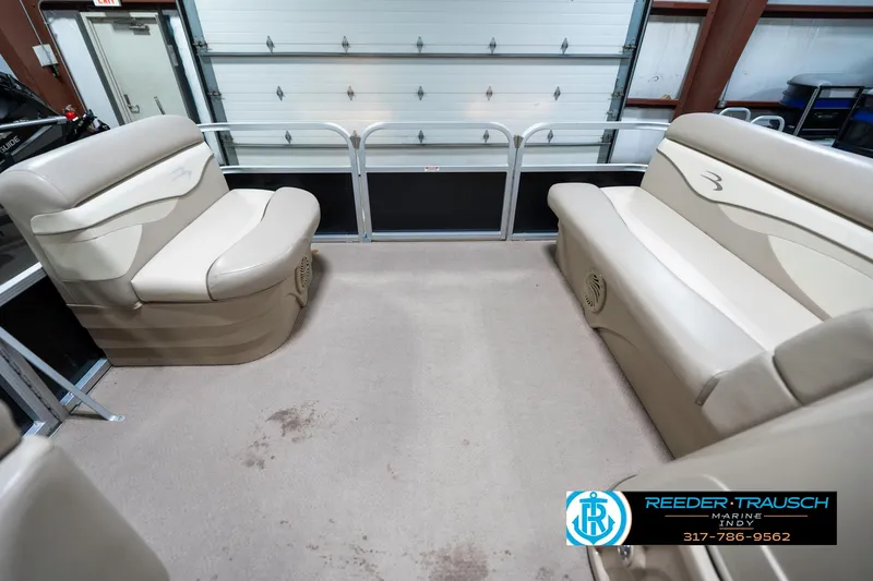 Slide: The Image of 2011 Bennington 17 Sli pontoon boat interior with beige seating and spacious layout. - 19