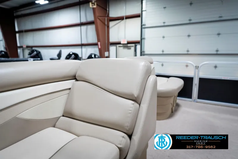 Slide: The Image of 2011 Bennington 17 Sli boat interior with beige seating in a showroom. - 21