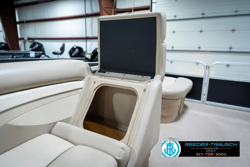 Slide: The Image of 2011 Bennington 17 Sli boat interior with open storage compartment, beige seating. - 22