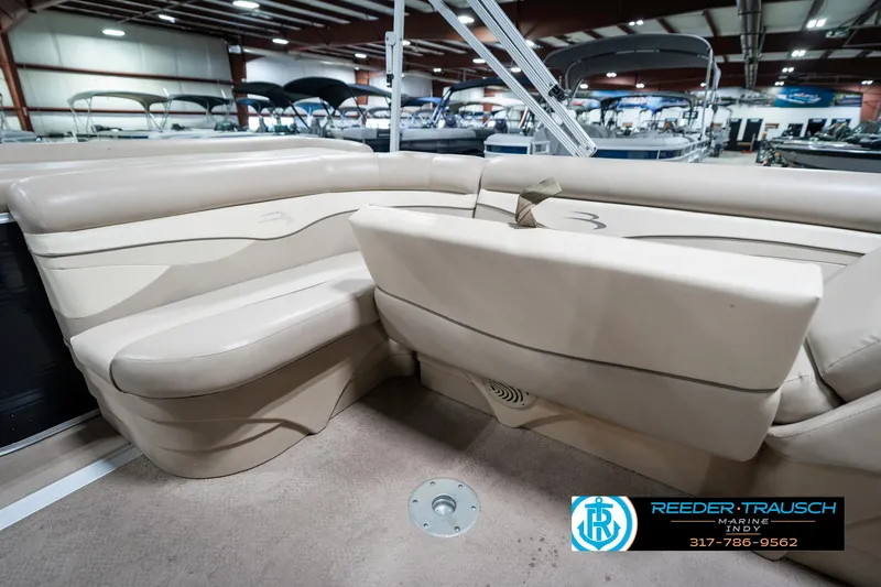Slide: The Image of 2011 Bennington 17 Sli boat interior with beige seating in showroom. - 25