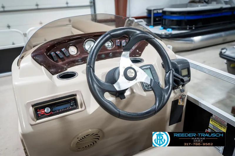 Slide: The Image of 2011 Bennington 17 Sli boat dashboard with steering wheel and control panel. - 27