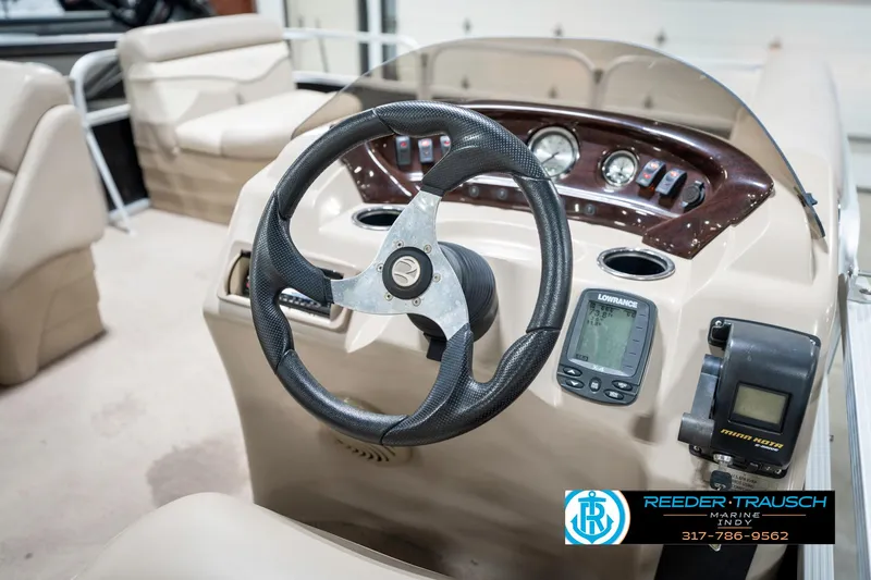 Slide: The Image of 2011 Bennington 17 Sli boat dashboard with steering wheel and navigation instruments. - 28
