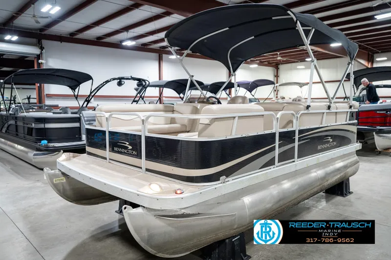 Slide: The Image of 2011 Bennington 17 Sli pontoon boat in showroom with canopy and seating. - 3