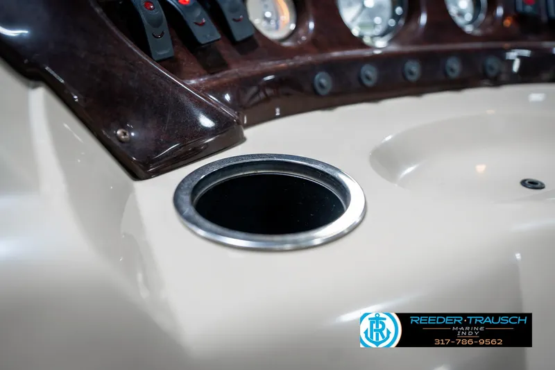 Slide: The Image of Dashboard of a 2011 Bennington 17 Sli boat with cup holder and controls. - 40