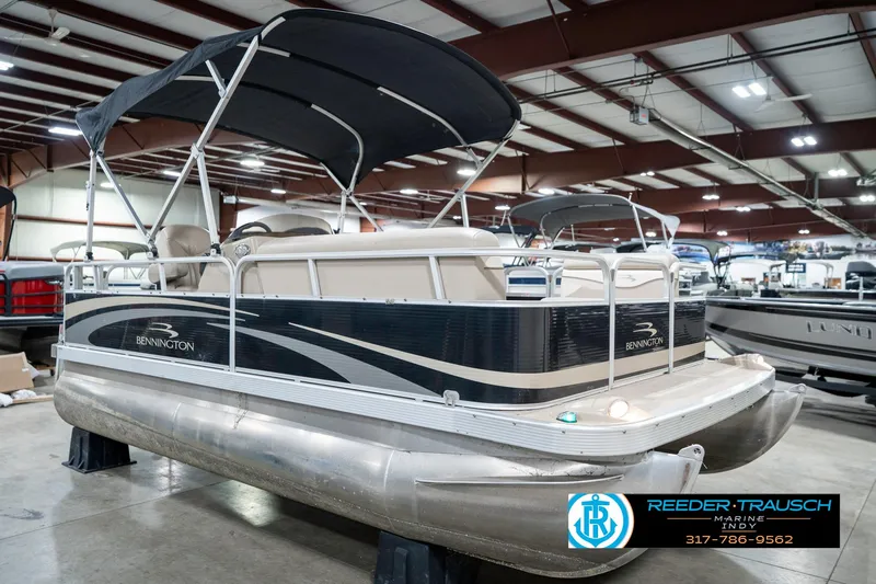 Slide: The Image of 2011 Bennington 17 Sli pontoon boat in indoor showroom with canopy. - 6