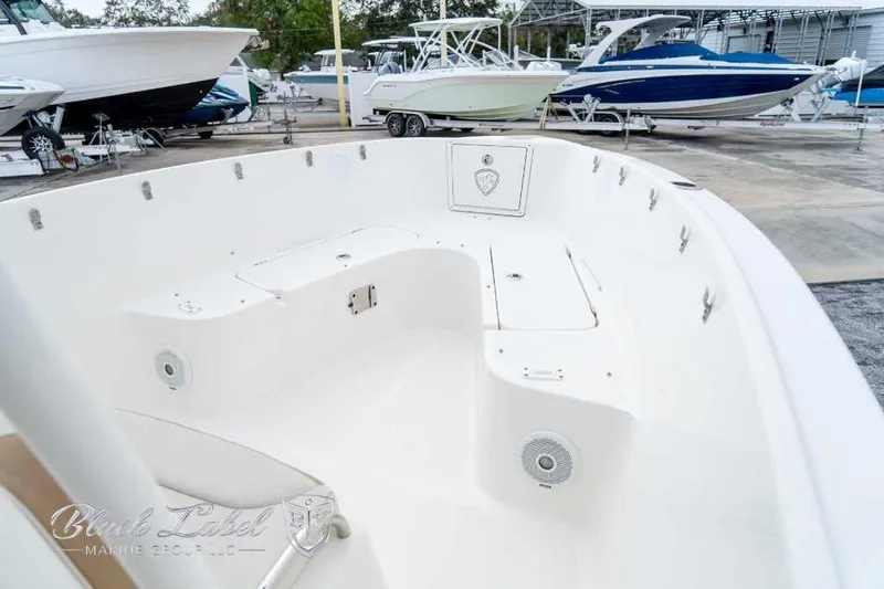 Slide: The Image of 2017 Century 2600 boat interior, showcasing spacious seating and storage in a marina setting. - 4