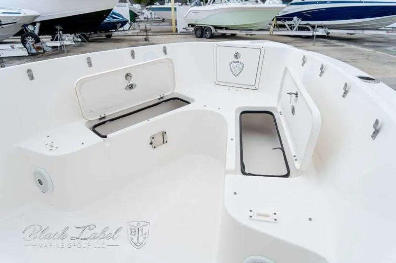Slide: The Image of 2017 Century 2600 boat interior with open storage compartments, displayed at a marina. - 8
