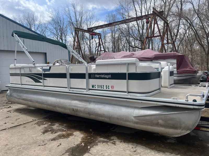 Slide: The Image of 2000 Harris-Kayot 220 Super Sunliner pontoon boat parked outdoors. - 0