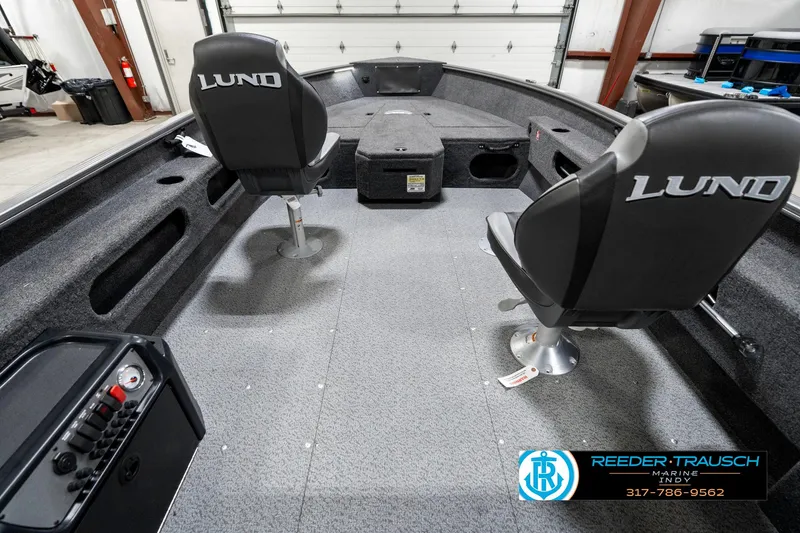 Slide: The Image of 2025 Lund 1775 Pro Guide boat interior with two seats and storage compartments. - 14