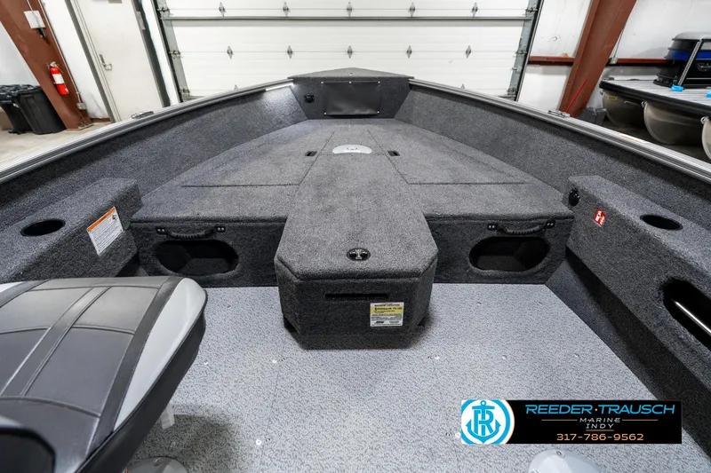 Slide: The Image of 2025 Lund 1775 Pro Guide boat interior with gray carpet and storage compartments. - 15