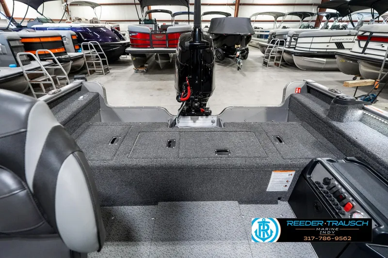 Slide: The Image of 2025 Lund 1775 Pro Guide boat interior with motor, in showroom setting. - 19