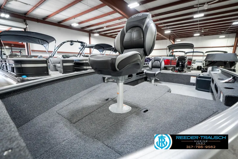 Slide: The Image of 2025 Lund 1775 Pro Guide boat interior with swivel seat in showroom. - 22