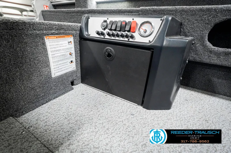 Slide: The Image of 2025 Lund 1775 Pro Guide boat console with control panel and storage compartment. - 25