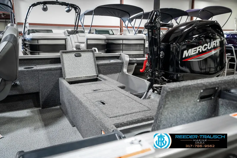 Slide: The Image of 2025 Lund 1775 Pro Guide boat interior with Mercury engine, featuring storage compartments. - 28