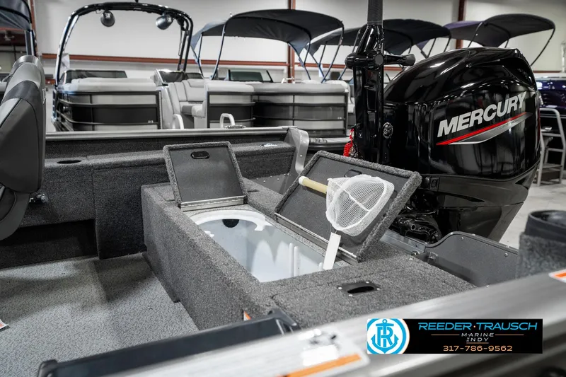 Slide: The Image of 2025 Lund 1775 Pro Guide boat interior with Mercury engine and fishing net. - 29