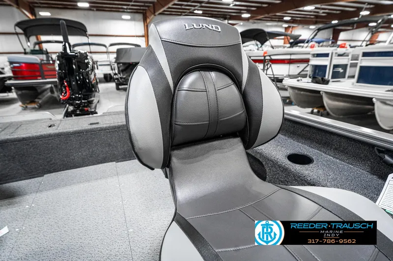 Slide: The Image of 2025 Lund 1775 Pro Guide boat interior with comfortable seating in showroom. - 33