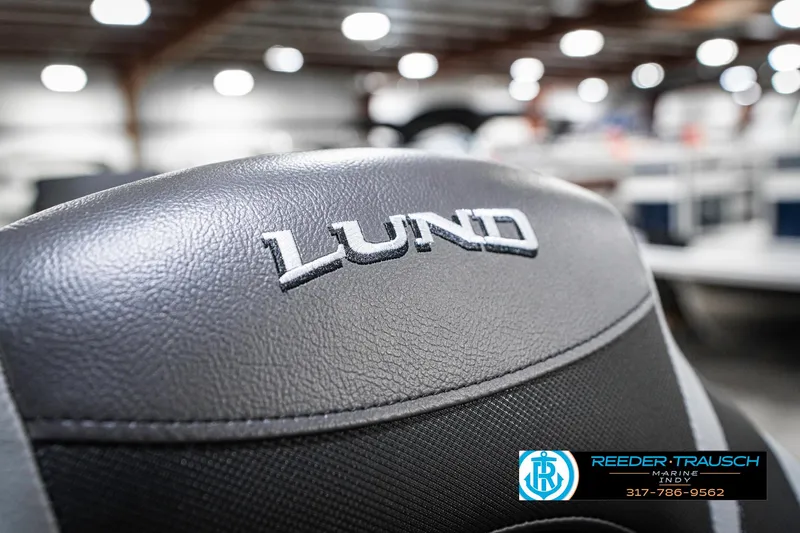 Slide: The Image of 2025 Lund 1775 Pro Guide boat seat with logo in showroom setting. - 34