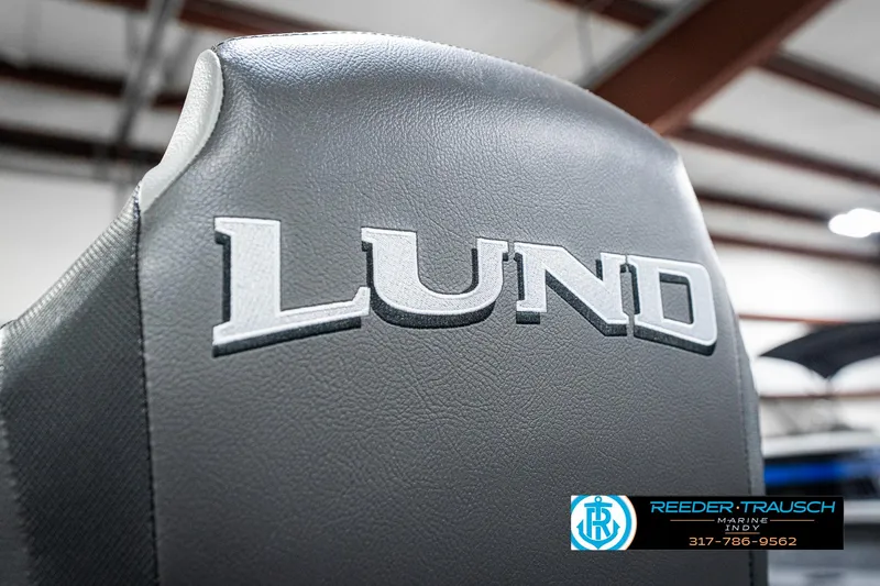 Slide: The Image of 2025 Lund 1775 Pro Guide boat seat with logo in showroom setting. - 35