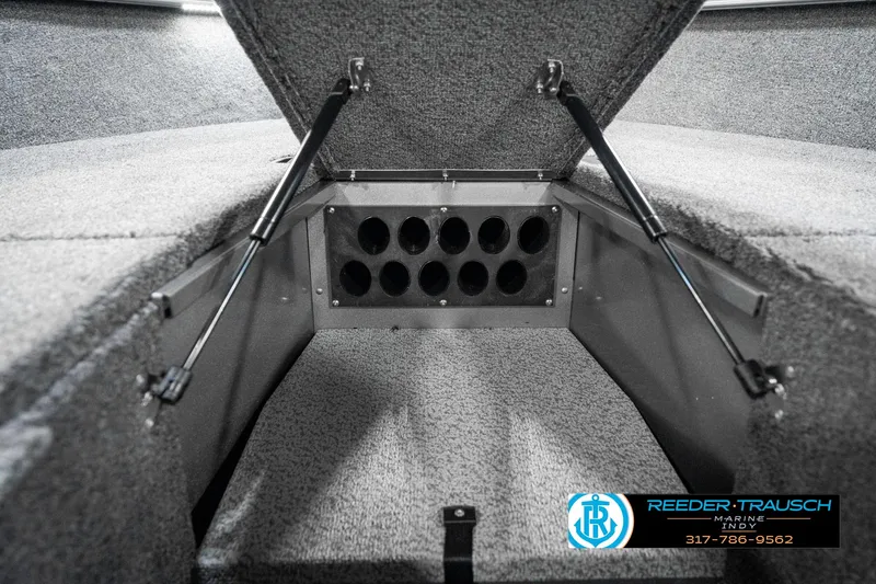 Slide: The Image of 2025 Lund 1775 Pro Guide boat storage compartment with hydraulic lifts and carpeted interior. - 37