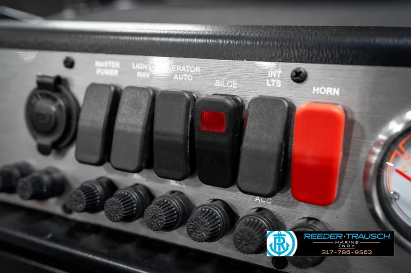Slide: The Image of Control panel of 2025 Lund 1775 Pro Guide boat with various switches and knobs. - 38