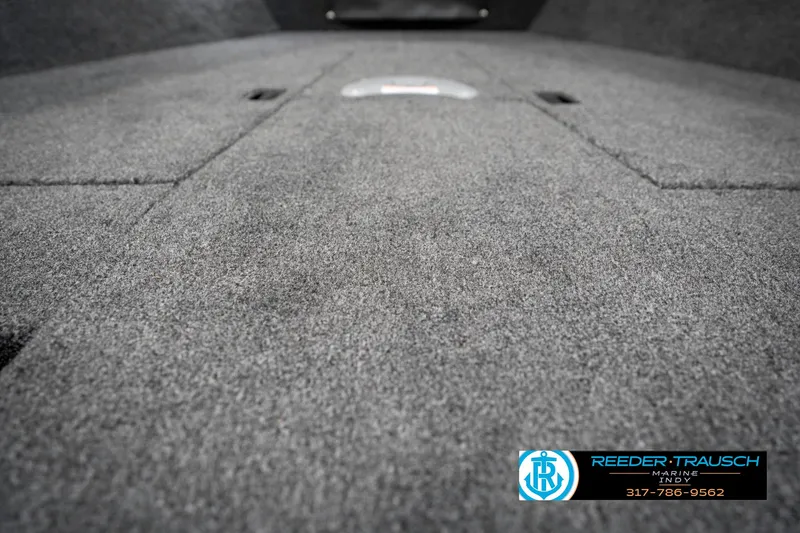 Slide: The Image of 2025 Lund 1775 Pro Guide boat interior with carpeted flooring, Reeder-Trausch branding visible. - 40