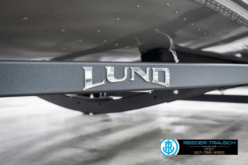 Slide: The Image of 2025 Lund 1775 Pro Guide boat trailer with logo, displayed at Reeder-Trausch Marine. - 48