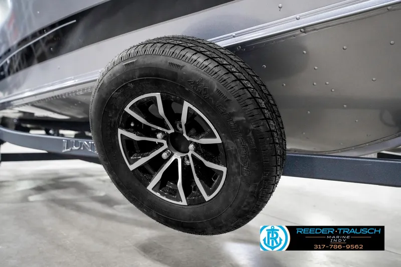 Slide: The Image of 2025 Lund 1775 Pro Guide boat trailer wheel, close-up view. - 49
