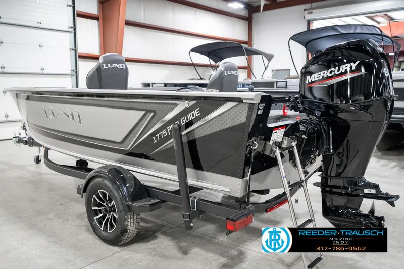 Slide: The Image of 2025 Lund 1775 Pro Guide boat with Mercury engine in showroom. - 8