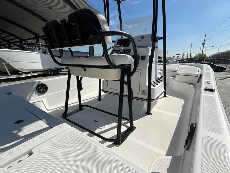 Slide: The Image of 2015 Epic 22 SC Center Console Bay Boat interior with seating and console, under a canopy. - 14