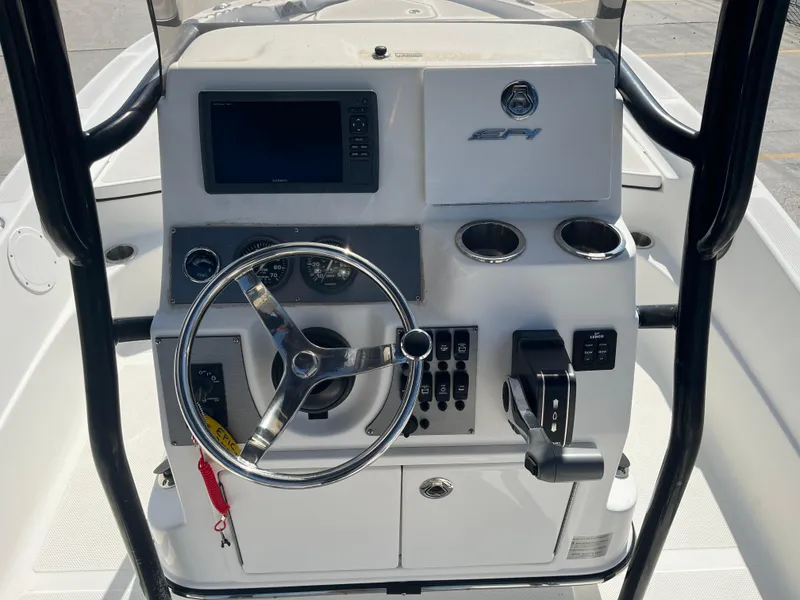 Slide: The Image of 2015 Epic 22 SC Center Console Bay Boat dashboard with steering wheel and controls. - 18