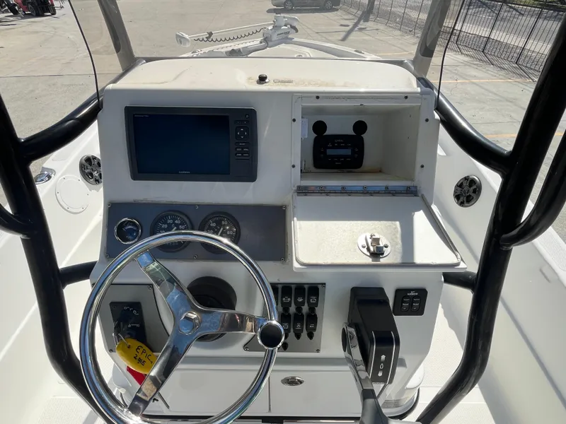 Slide: The Image of 2015 Epic 22 SC Center Console Bay Boat dashboard with steering wheel and navigation controls. - 19