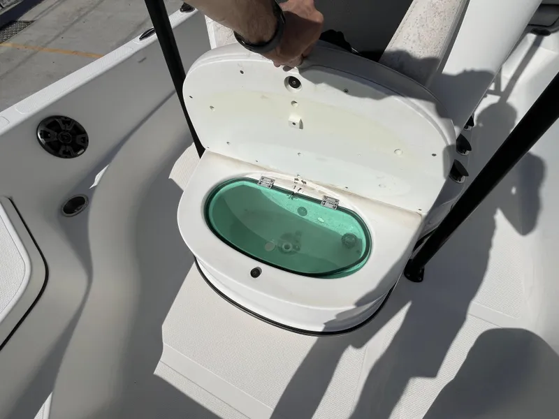 Slide: The Image of 2015 Epic 22 SC Center Console Bay Boat livewell open, showing interior. - 21