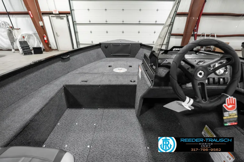 Slide: The Image of 2025 Lund 1650 Rebel XL SS boat interior with steering wheel and dashboard. - 15