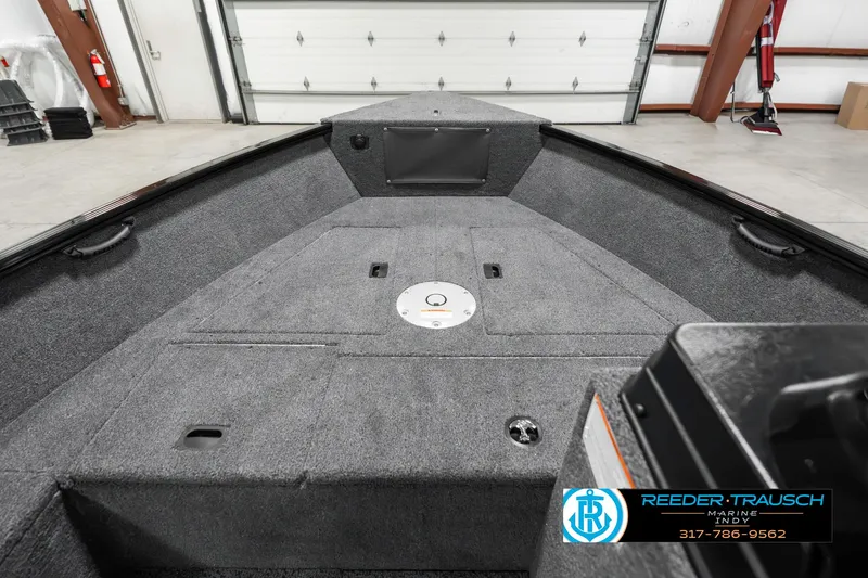 Slide: The Image of 2025 Lund 1650 Rebel XL SS boat interior in a garage setting. - 16