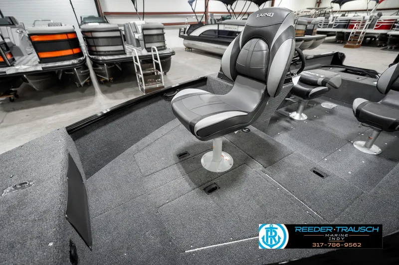 Slide: The Image of 2025 Lund 1650 Rebel XL SS boat interior with swivel seat in showroom. - 22