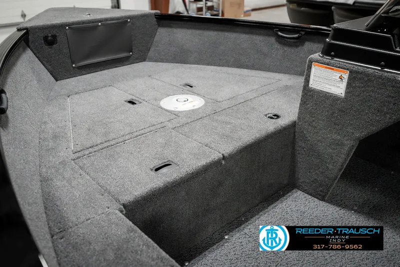 Slide: The Image of 2025 Lund 1650 Rebel XL SS boat interior with gray carpeted deck. - 23