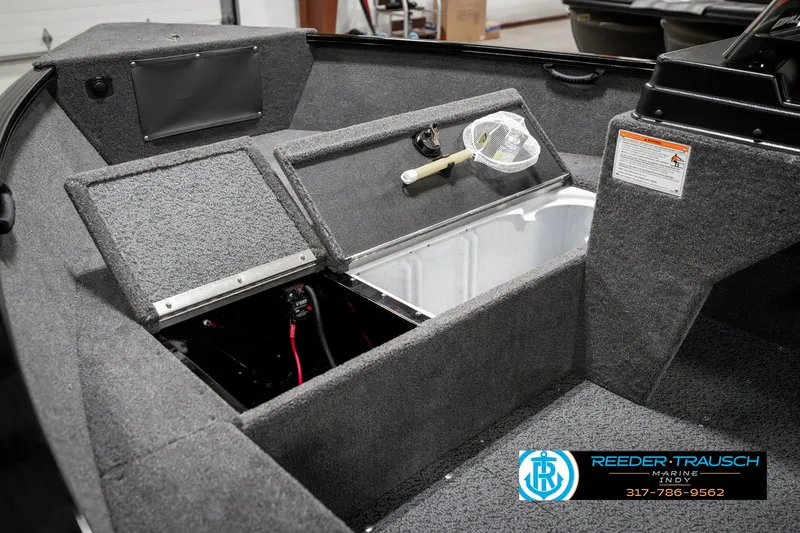 Slide: The Image of 2025 Lund 1650 Rebel XL SS boat interior with storage compartments and fishing net. - 24