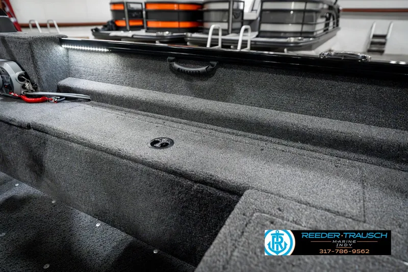 Slide: The Image of 2025 Lund 1650 Rebel XL SS boat interior with carpeted storage area. - 25