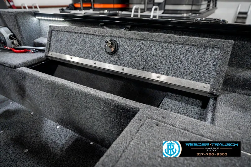 Slide: The Image of 2025 Lund 1650 Rebel XL SS boat interior storage compartment, open and empty. - 26