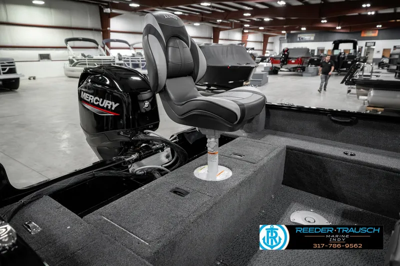 Slide: The Image of 2025 Lund 1650 Rebel XL SS boat interior with Mercury engine in showroom. - 27