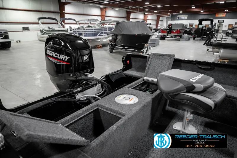 Slide: The Image of 2025 Lund 1650 Rebel XL SS boat interior with Mercury engine in showroom. - 29