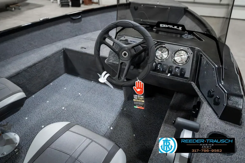 Slide: The Image of 2025 Lund 1650 Rebel XL SS boat interior with steering wheel and dashboard controls. - 30