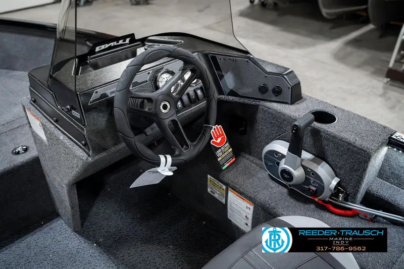 Slide: The Image of 2025 Lund 1650 Rebel XL SS boat interior with steering wheel and control panel. - 31