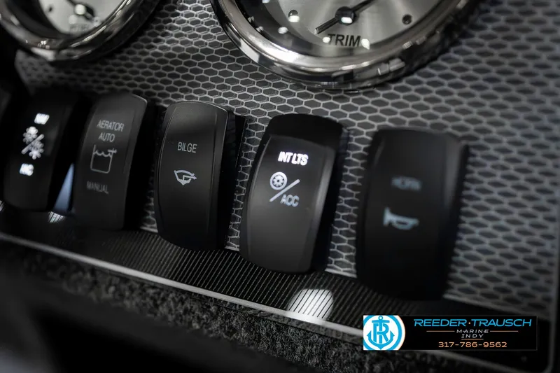 Slide: The Image of Dashboard controls of 2025 Lund 1650 Rebel XL SS boat, featuring various switches and dials. - 35